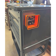 A dark gray metal tool chest with multiple drawers and a bright orange pop up tray held vertically to the side . The orange panel features a square window with the brand name 'BONDHUS' visible inside.