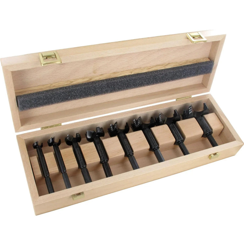 Set of 8 black forstner bits in a wooden box on a white background