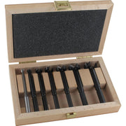 Set of 7 black forstner bits in a wooden box on a white background