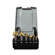 A set of seven metal rotary burr bits in graduated sizes, displayed in a black plastic holder with size labels, and an open gray plastic storage case behind them, on a white background.